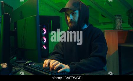 Caucasian man typing keyboard computer desktop pc online cyber crime virtual networks browser programmer coding monitor user connected ecommerce Stock Photo