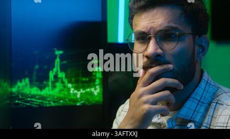 Indian Arabian man programmer businessman business working trader analysing chart strategy male take off glasses unhealthy eyes strain pain headache Stock Photo