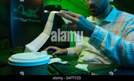 Caucasian focused man programmer checking coding guy coder male professional digital engineer IT support drinking coffee typing working on desktop Stock Photo