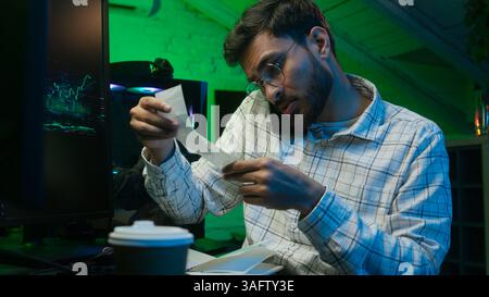 Arabian Indian man male guy work employee engineer programmer hacker freelance coding cyberspace call mobile phone talking office database code Stock Photo