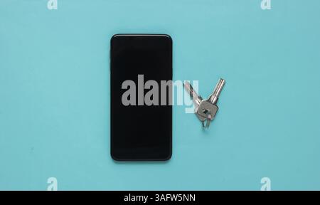 Protecting your smartphone’s personal data. Smartphone with keys on blue pastel background. Top view Stock Photo