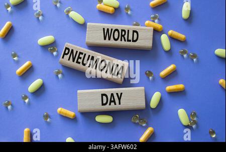 Medicine symbol. Concept words World Pneumonia Day on wooden blocks. Beautiful purple background with pills. Medicine concept and World Pneumonia Day. Stock Photo