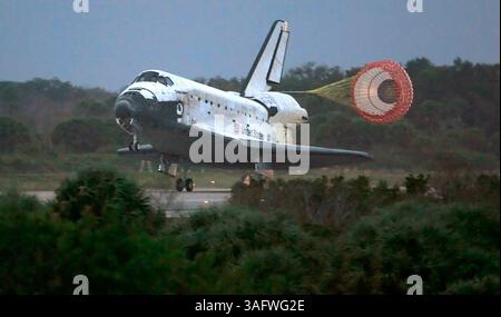 Space Shuttle Discovery deploys its drag chute as the vehicle comes to ...
