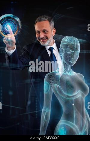 Mature businessman in a suit smiling while activating a digital interface next to a glowing female humanoid hologram, symbolizing AI and futuristic te Stock Photo