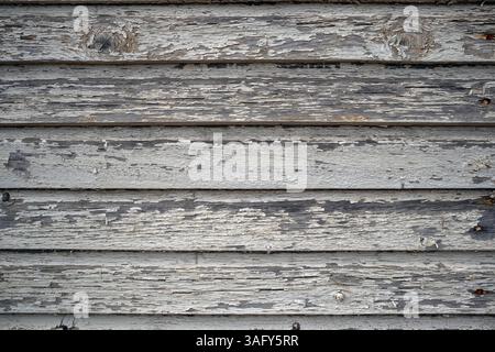 wall of an old wooden house with peeling paint Stock Photo