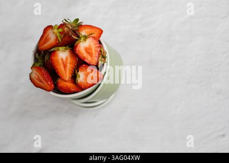 top view np Several small bowls stand on each other where strawberries lie Stock Photo