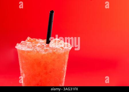Red strawberry slushie isolated on red background Stock Photo