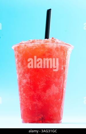 Red strawberry slushie isolated on blue background Stock Photo