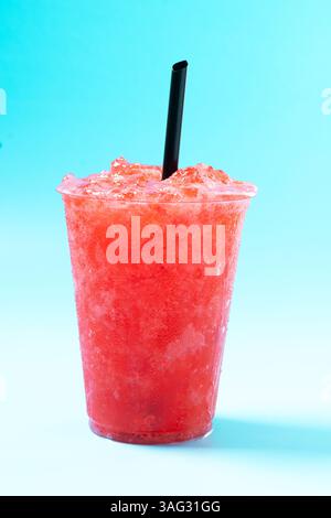 Red strawberry slushie isolated on blue background Stock Photo
