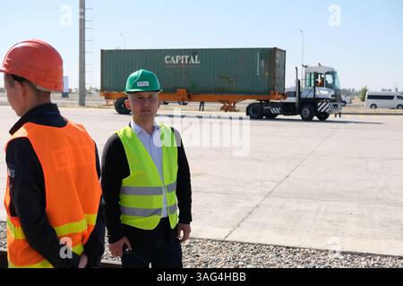 A security and control officer monitors the unloading of containers ...
