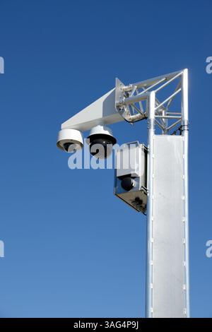 Surveillance cameras mounted on the pole with blue sky Stock Photo