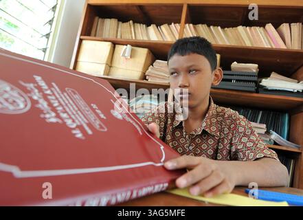 Aug. 2, 2012 - Surabaya, East Java, Indonesia - A blind boy start to learn Braille Quran..The Braille Quran learning literacy program for blind students in 7th  grade junior high school for disability  (category A - Blind Children Education Foundation) conducted intensively in the month of Ramadan. Method of learning by using songs and Hijaiyah letter yellow cards. (Credit Image: © Robertus Pudyanto/ZUMAPRESS.com) Stock Photo