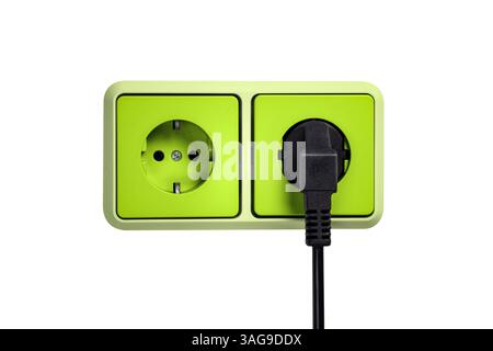 Green outlet with a plug on a wall isolated on white Stock Photo