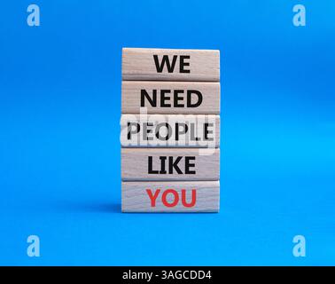 Hiring symbol. Wooden blocks with words We need People like You. Beautiful blue background. Business and Hiring concept. Copy space. Stock Photo
