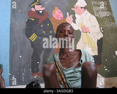 Jan 17, 2009 - Angola - A malnourished boy sits in front of a mural painting at the MSF feeding centre in Angola. Feeding centres and other humanitarian aid were organized in Angola after widescale malnutrition during and following the country's civil war (Credit Image: Ton Koene/ZUMAPRESS.com) Stock Photo