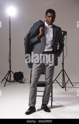 Confident man in stylish suit posing in professional photography studio. Fashion, style, portrait, confidence, elegant, male Stock Photo