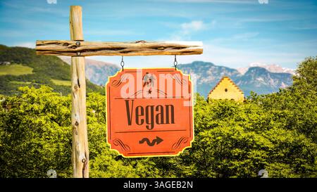 An image with a signpost in German pointing in the direction of Vegan. Stock Photo