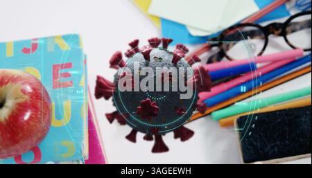 Image of Covid 19 coronavirus cell spinning, scope scanning over desk with school items Stock Photo