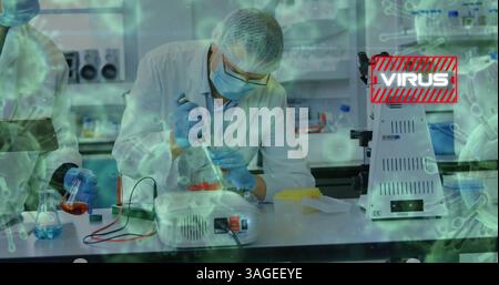 Conducting virus research, scientists in laboratory using pipettes and advanced equipment Stock Photo