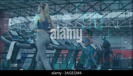 Digital interface with medical data processing against fit people running on treadmill at gym Stock Photo