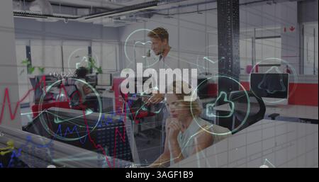Financial data processing and digital icons against male and female colleague working together Stock Photo