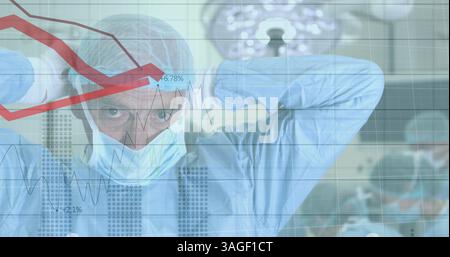 Financial data processing against caucasian male surgeon wearing face mask Stock Photo