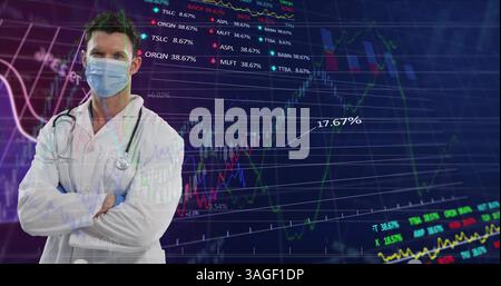 Portrait of caucasian male doctor wearing face mask against financial data processing Stock Photo