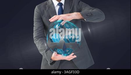 Image of virtual globe with medical icons held by businessman Stock Photo