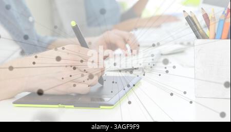 Image of network of connections over person using graphic tablet and computer Stock Photo