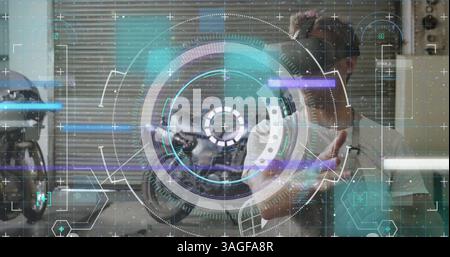 Data processing and scope scanning over caucasian man wearing vr headset in the garage Stock Photo