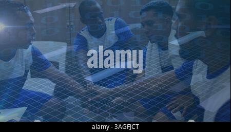 Image of arrows and binary coding over football players stacking hands in changing rooms Stock Photo