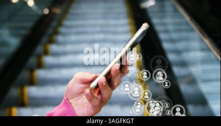 Image of network of people icons over woman using smartphone Stock Photo