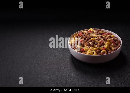 Flakes, chocolate balls and dried fruit for a hearty breakfast. Granola with chocolate flakes Stock Photo