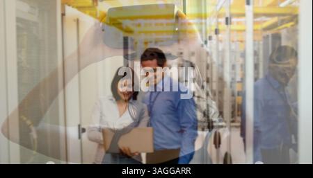 Holding smartphone, image over business people working in data center Stock Photo