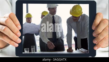 Hands holding digital tablet showing architect working Stock Photo