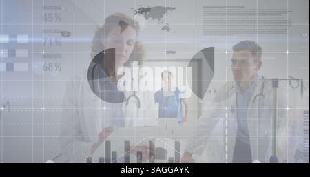 Statistical data processing against male and female doctor discussing at hospital Stock Photo