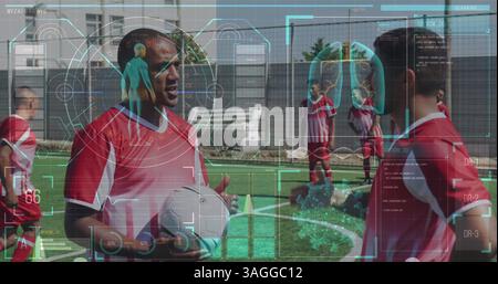 Digital interface with medical data processing against two male soccer players talking on grass turf Stock Photo
