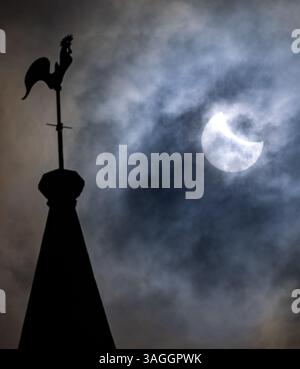Picture shows the the partial eclipse in Ely,Cambridgeshire over the spire at St Mary’s Church on Saturday morning.    The partial solar eclipse will Stock Photo