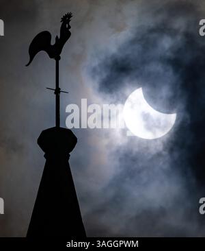Picture shows the the partial eclipse in Ely,Cambridgeshire over the spire at St Mary’s Church on Saturday morning.    The partial solar eclipse will Stock Photo