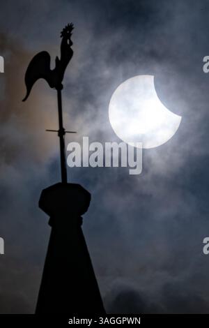Picture shows the the partial eclipse in Ely,Cambridgeshire over the spire at St Mary’s Church on Saturday morning.    The partial solar eclipse will Stock Photo