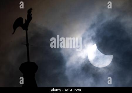 Picture shows the the partial eclipse in Ely,Cambridgeshire over the spire at St Mary’s Church on Saturday morning.    The partial solar eclipse will Stock Photo