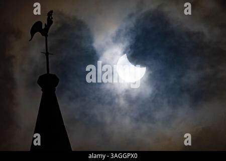 Picture shows the the partial eclipse in Ely,Cambridgeshire over the spire at St Mary’s Church on Saturday morning.    The partial solar eclipse will Stock Photo