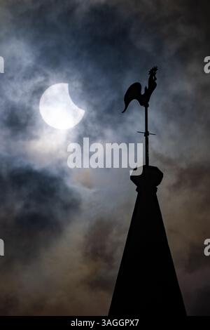 Picture shows the the partial eclipse in Ely,Cambridgeshire over the spire at St Mary’s Church on Saturday morning.    The partial solar eclipse will Stock Photo