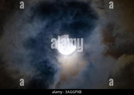 Picture shows the the partial eclipse in Ely,Cambridgeshire over the spire at St Mary’s Church on Saturday morning.    The partial solar eclipse will Stock Photo