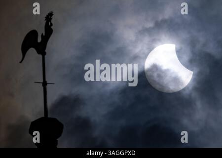 Picture shows the the partial eclipse in Ely,Cambridgeshire over the spire at St Mary’s Church on Saturday morning.    The partial solar eclipse will Stock Photo