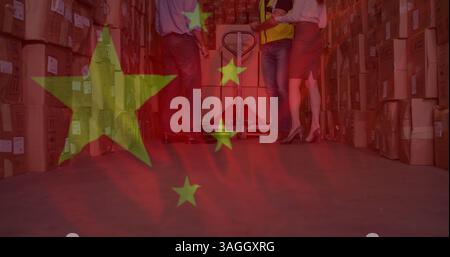 Image of chinese flag flowing over people working in warehouse Stock Photo