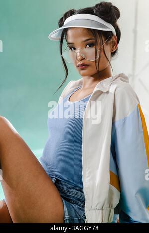 African American woman in casual outfit posing confidently in studio setting. Confidence, fashion, diverse, style, individuality, portrait Stock Photo