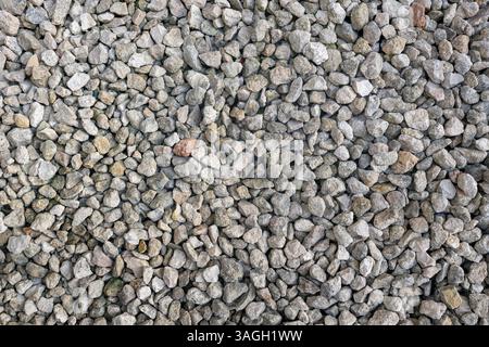 High-resolution close-up of small natural gravel stones. Ideal for backgrounds, construction themes, or nature textures. Stock Photo
