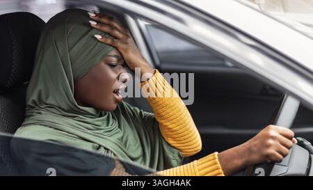 Driving Anxiety. Stressed Black Muslim Lady In Hijab Having Car Accident Stock Photo