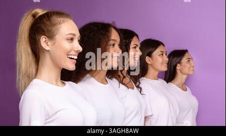 Five Smiling Diverse Women Standing In Row On Purple Background Stock Photo